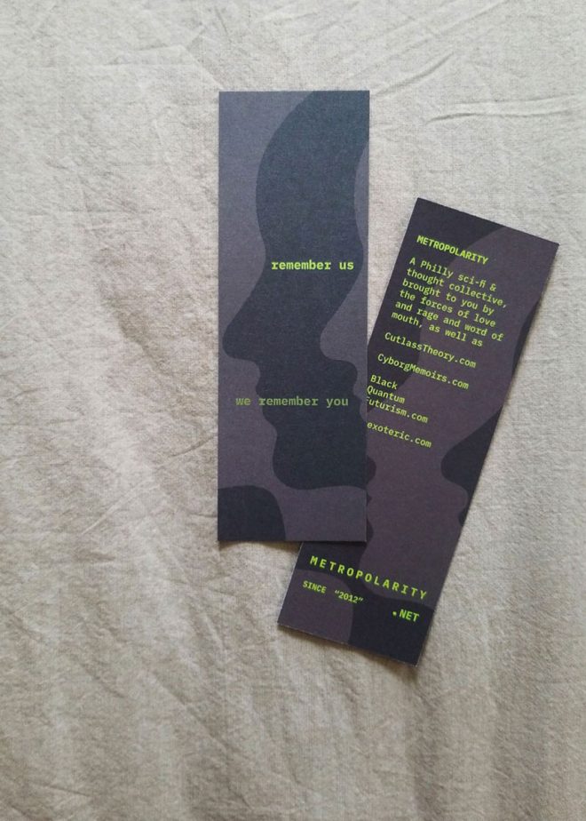 2 Metropolarity bookmarks show the front and back of the same design, on a cotton bedsheet. The design has member URLs and info on one side, and 'remember us / we remember you' on the other.